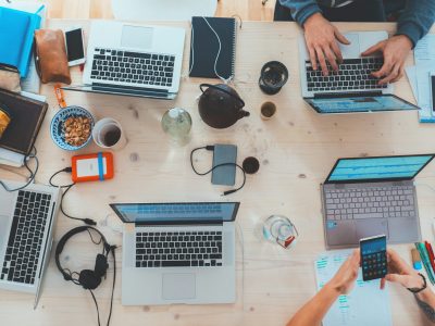 Off page SEO collaboration with team using laptops and mobile devices for outreach and promotion